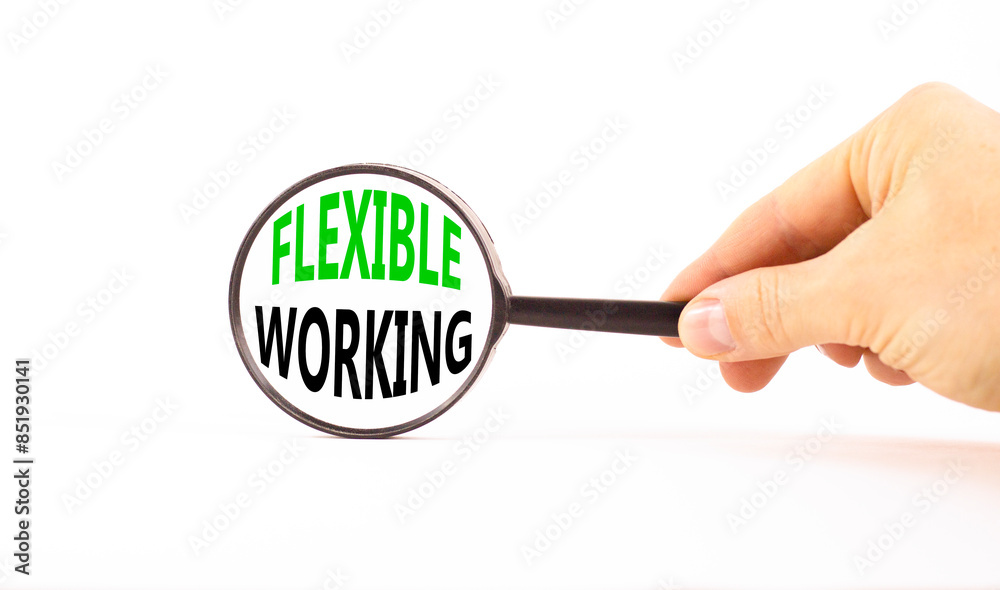 Flexible working symbol. Concept words Flexible working in beautiful magnifying glass. Beautiful white paper background. Businessman hand. Business flexible working concept. Copy space. Flexible working symbol. Concept words Flexible working in beautiful magnifying glass. Beautiful white paper background. Businessman hand. Business flexible working concept. Copy space.
