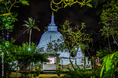 traditional Sri Lankan white temple stupas in evening. photo