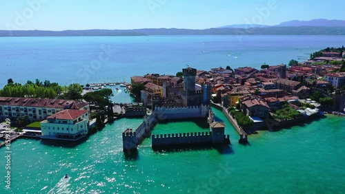 Castello Scaligero di Sirmione Lake Garda Aerial View with Blue Water and Shoreline, Idyllic Summer Vacation Destination, Clear Sky and Historic Castle Background