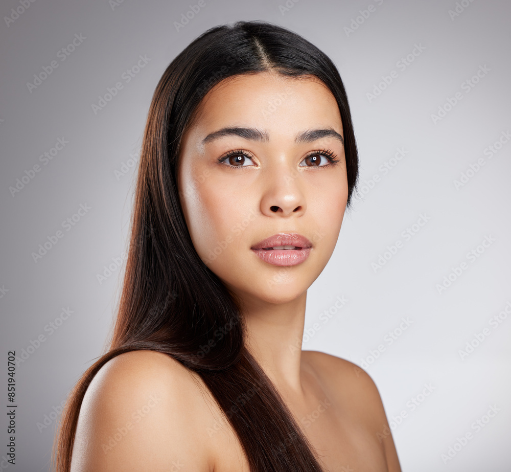 Fototapeta premium Hair care, glow or girl with beauty, portrait or style for confidence, results or keratin treatment. Face, shine or model woman in studio on grey background for wellness, natural growth or cosmetics