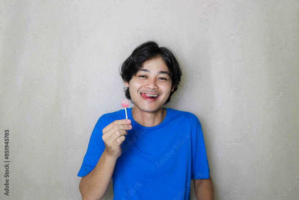 portrait of a very attractive random handsome Asian Indonesian man on a white isolated background wearing blue clothes portrait of a very attractive random handsome Asian Indonesian man on a white isolated background wearing blue clothes