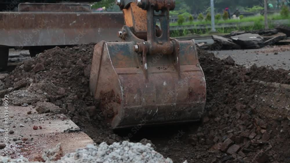Excavator digs trench in the construction site, close up backhoe digger Excavator digs trench in the construction site, close up backhoe digger