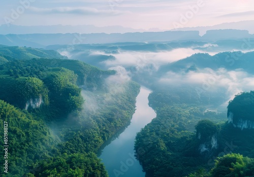 The winding river is surrounded by dense forests, with green trees on both sides 