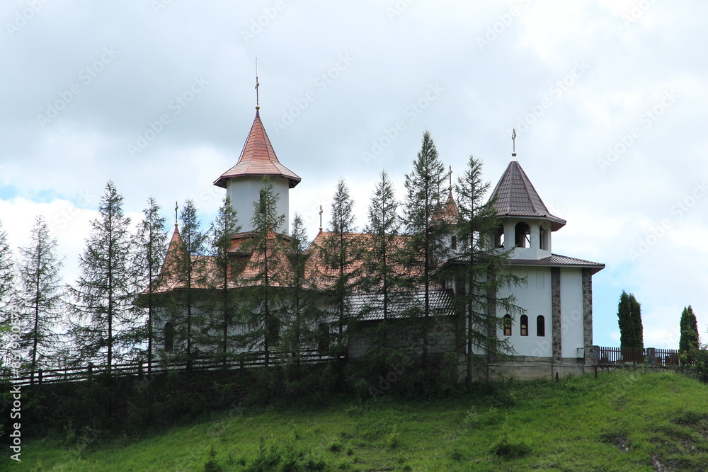 A building with a tower and a cross on top of it A building with a tower and a cross on top of it