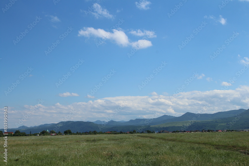 A field with blue sky and clouds A field with blue sky and clouds