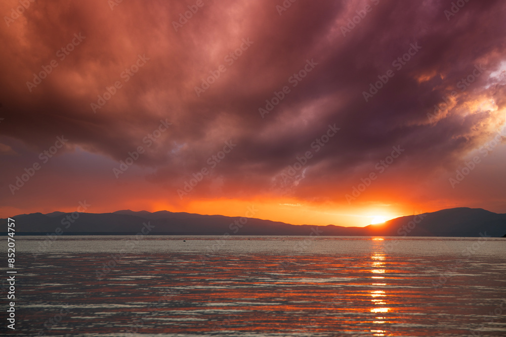 Beautiful bright sunset over the lake and Mountains. Beautiful bright sunset over the lake and Mountains.