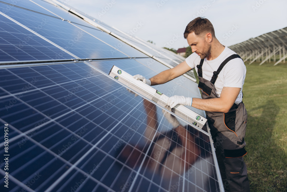 Photovoltaic, solar panel and maintenance worker using a building level ruler during inspection. Solar energy, renewable energy and man doing checkup of electricity sustainability innovation Photovoltaic, solar panel and maintenance worker using a building level ruler during inspection. Solar energy, renewable energy and man doing checkup of electricity sustainability innovation
