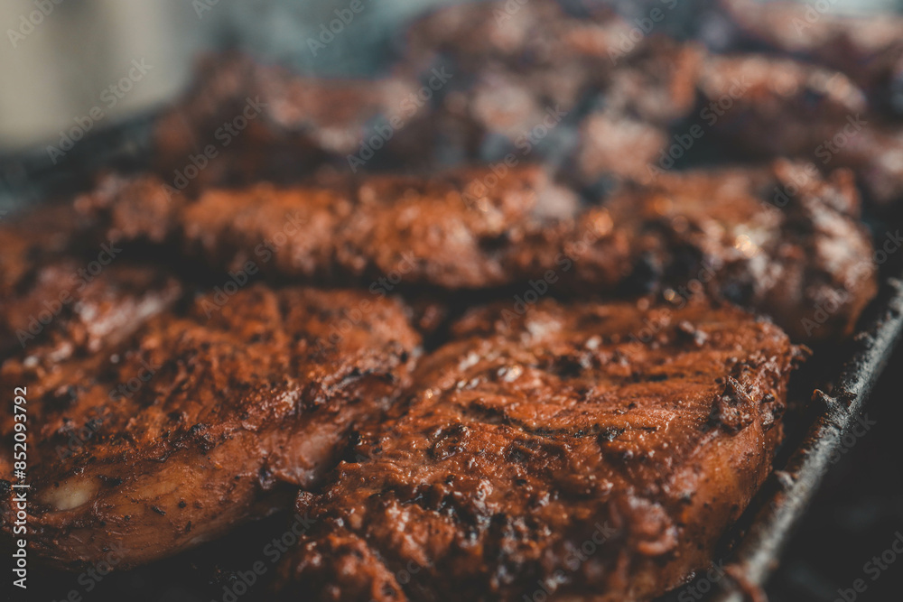 Man hand grilling barbecue with smoked pork at backyard on day. Family dinner outdoor style bbq activity Man hand grilling barbecue with smoked pork at backyard on day. Family dinner outdoor style bbq activity