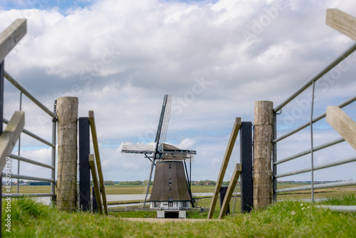 Traditional Molen Het Noorden (Windmills The North) A Dutch polder mill, Spring landscape with flat and low land with blue sky, Oosterend, Texel is the wadden islands in the Netherlands, North Holland photo