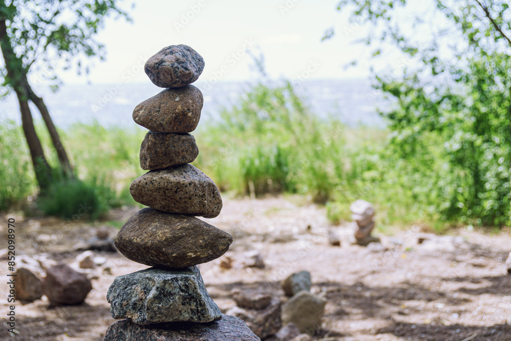 Pile of rough stones stacked on the shore symbolizes balance and tranquility Pile of rough stones stacked on the shore symbolizes balance and tranquility