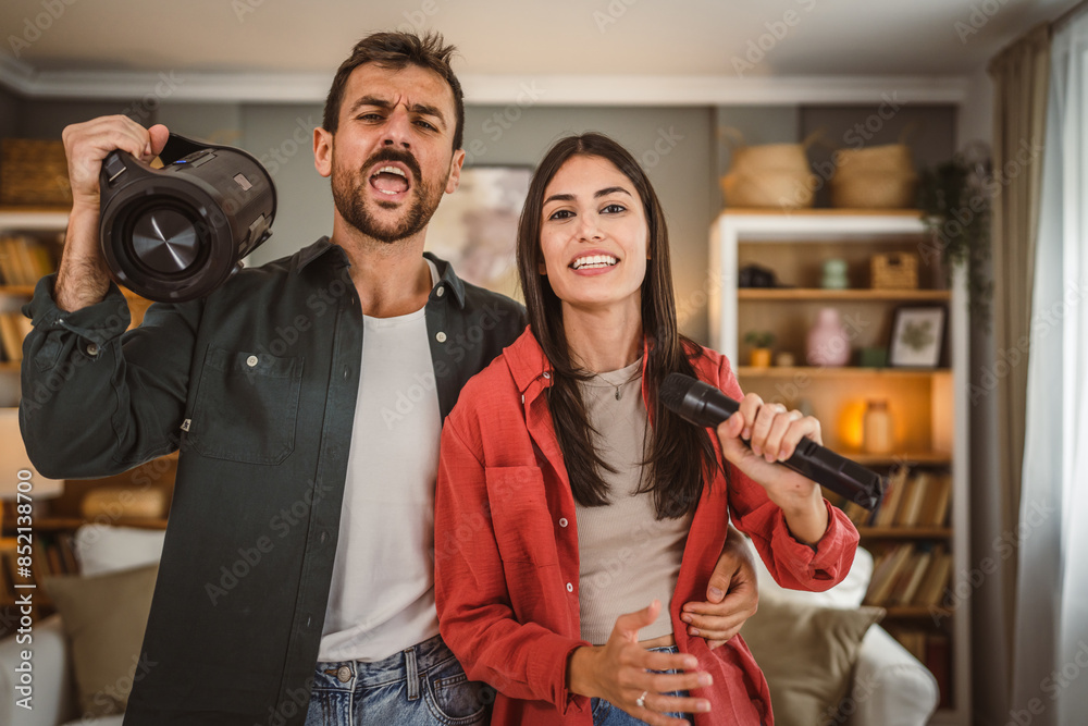 Woman hold microphone and sing, man hold loudspeaker karaoke party Woman hold microphone and sing, man hold loudspeaker karaoke party