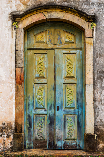 Old wooden door from a historic church in Ouro Preto, Minas Gerais, Brazil.