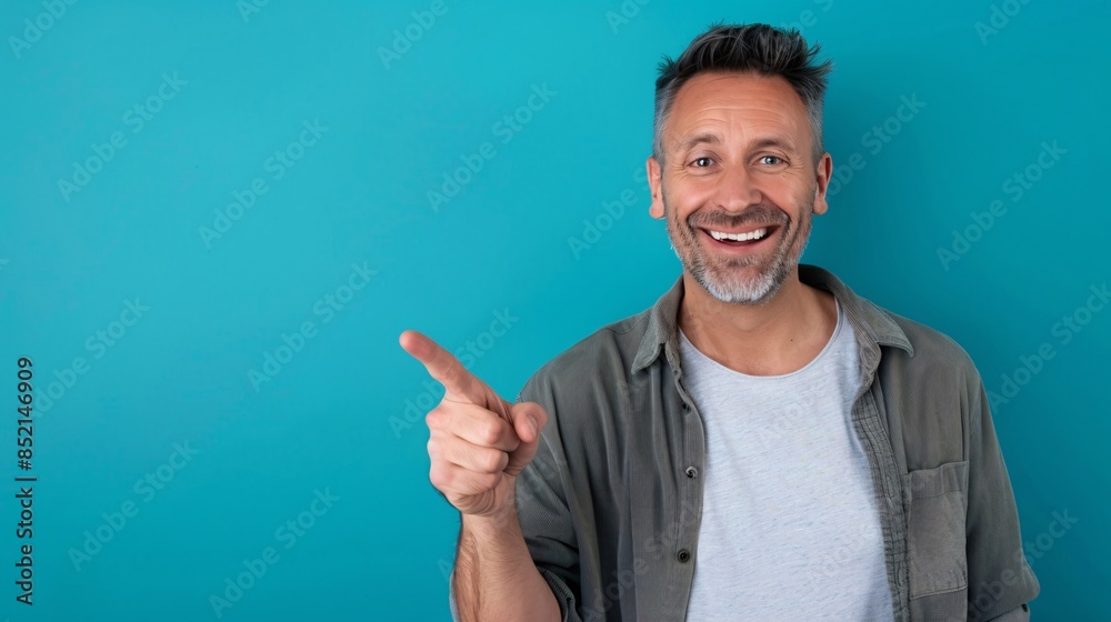 Smiling Man Pointing with a Blue Background Smiling Man Pointing with a Blue Background