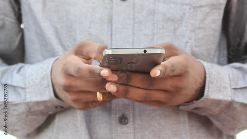 Close up of Man text messaging on mobile phone