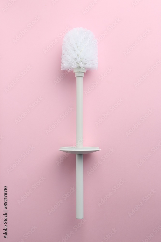 One toilet brush on pink background, top view One toilet brush on pink background, top view