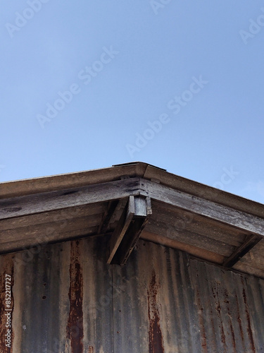 tile roof of home with blue sky © mansum008