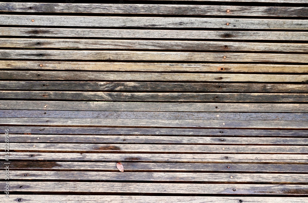 Natural close up wooden boards damp wet bench chair seating texture after rain surface area isolated on horizontal ratio full frame background.