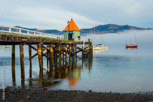 Obraz na płótnie Wooden Wharf at Akaroa Beach on the Banks Peninsula, southeast of Christchurch, South Island, New Zealand w salonie