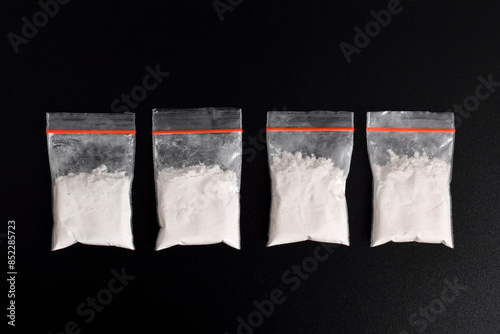 Foto Cocaine in plastic packet isolated on black background