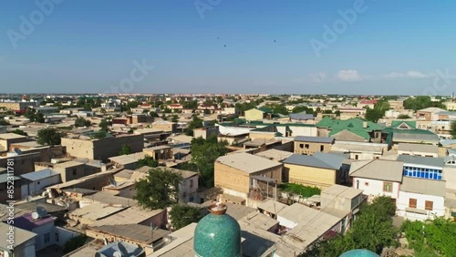 A drone flies around the Chor Minor, the Madrasah of Khalif Niyaz-kul. Old Bukhara, Uzbekistan. Sunny summer day. photo