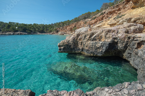 Turquoise waters of Cala Saladeta in Ibiza in summer photo