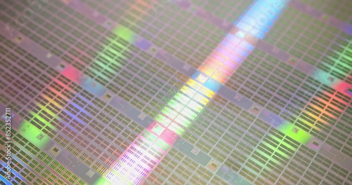 A close-up view of a silicon wafer's microprocessor circuit layout. The semiconductors or central processing unit CPU microchips are fabricated from a silicon wafer with patterned layers of materials.