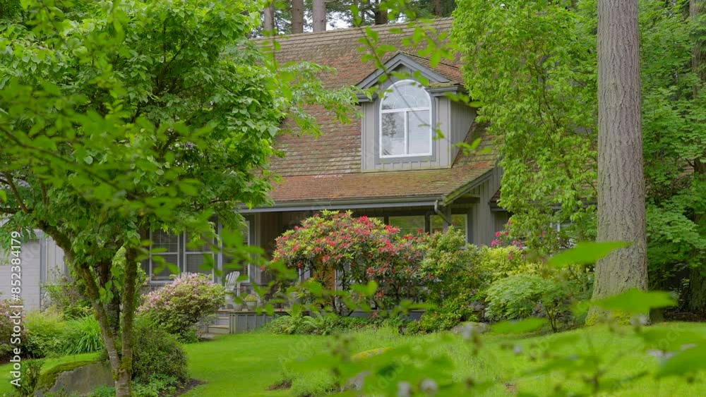 Establishing shot of luxury house with big tree and nice spring blossom landscape in Vancouver, Canada, North America. Day time on June 2024. ProRes 422 HQ. Establishing shot of luxury house with big tree and nice spring blossom landscape in Vancouver, Canada, North America. Day time on June 2024. ProRes 422 HQ.