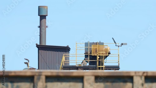 Industrial equipment in scrapyard recycling material delivered by dump trucks