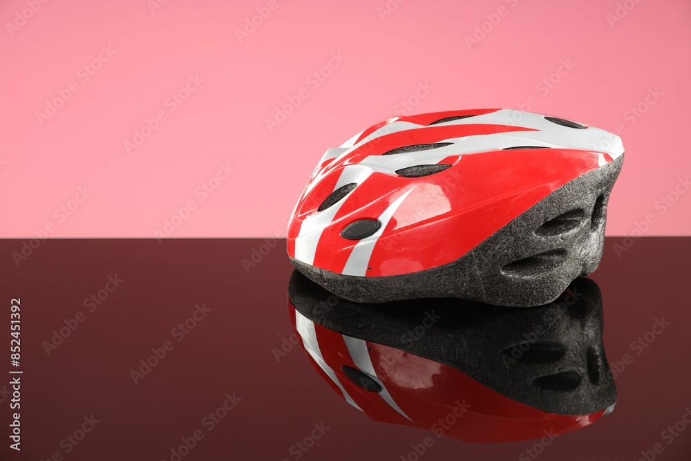 Protective helmet on mirror surface against pink background. Space for text Protective helmet on mirror surface against pink background. Space for text