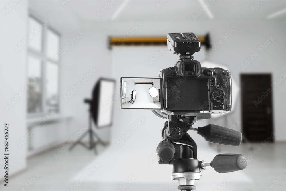 Professional camera on tripod in photo studio Professional camera on tripod in photo studio