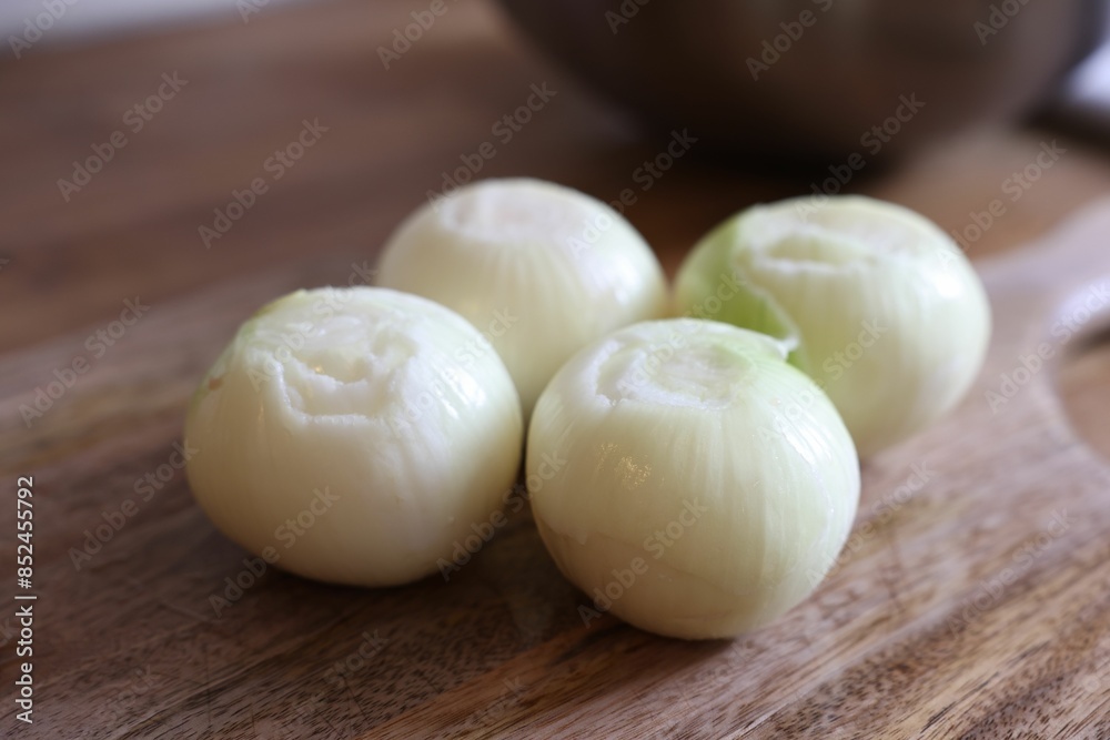 Fresh ripe onion bulbs on wooden table, closeup Fresh ripe onion bulbs on wooden table, closeup