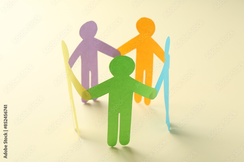 Equality concept. Paper human figures on beige background, closeup