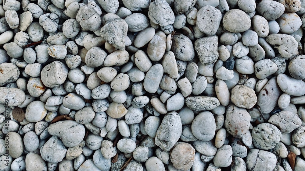 White round pebble stones background, rough texture of the stone, material for the garden decoration White round pebble stones background, rough texture of the stone, material for the garden decoration