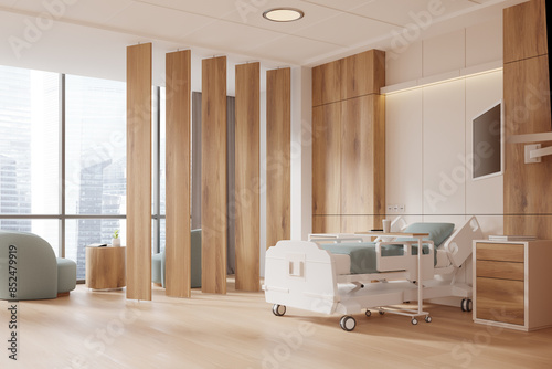 Wooden hospital room interior with bed, armchairs and panoramic window photo