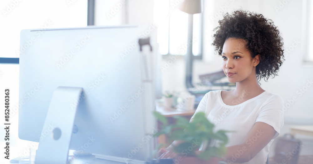 Black woman, typing and reading with computer at office desk for administration or data capturing. Young African, female person or employee working on PC for research, browsing or email at workplace Black woman, typing and reading with computer at office desk for administration or data capturing. Young African, female person or employee working on PC for research, browsing or email at workplace