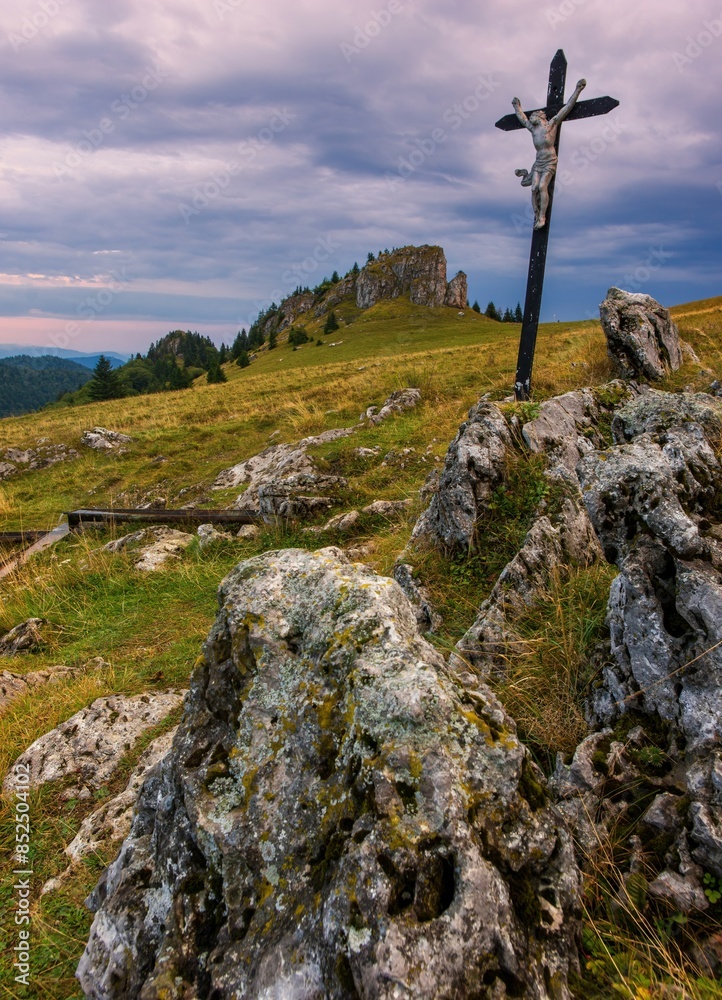 Fototapeta premium Mountain landscape with rocks, pastures for cattle and a small cross in the background. Slovak mountain nature Velka Fatra, Kralova Studna