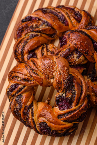 Delicious fresh baked bun with poppy seeds and berries photo