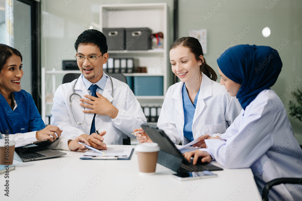 Obraz premium Medical, meeting and laptop for team in discussion, brainstorming and planning. Doctor, nurse on desk show diversity in collaboration, teamwork or workshop in hospital .