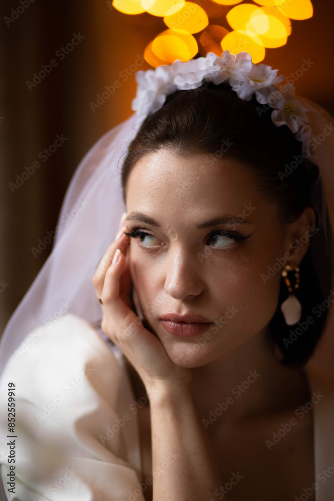 Fototapeta premium sensual portrait of a young woman bride in warm light.
