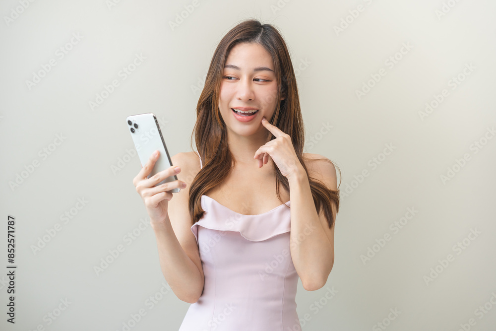 Asian young woman happy hold mobile, read good news online feel excited getting offer, great positive surprise, joy celebrate success on phone. Businesswoman isolated on white background, copy space Asian young woman happy hold mobile, read good news online feel excited getting offer, great positive surprise, joy celebrate success on phone. Businesswoman isolated on white background, copy space