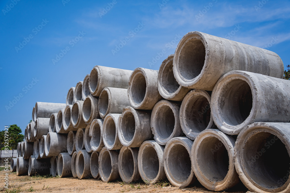 A stack of concrete ring pipes piled and creating a symmetrical arrangement A stack of concrete ring pipes piled and creating a symmetrical arrangement