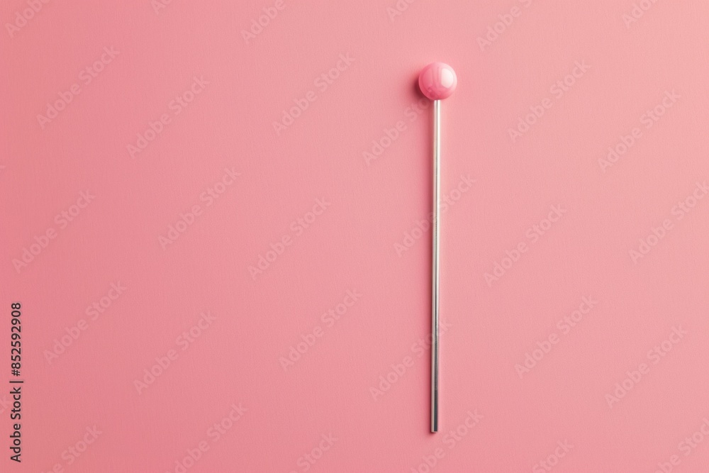 A single pink lollipop on a bright pink background, perfect for use in branding, marketing, or creative projects A single pink lollipop on a bright pink background, perfect for use in branding, marketing, or creative projects