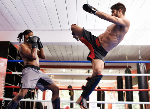 Fighter, kickboxing and training with opponent in ring for challenge, competitive and athlete for strength in gym. Man, healthy and fitness from practice in exercise studio for sport or action of MMA