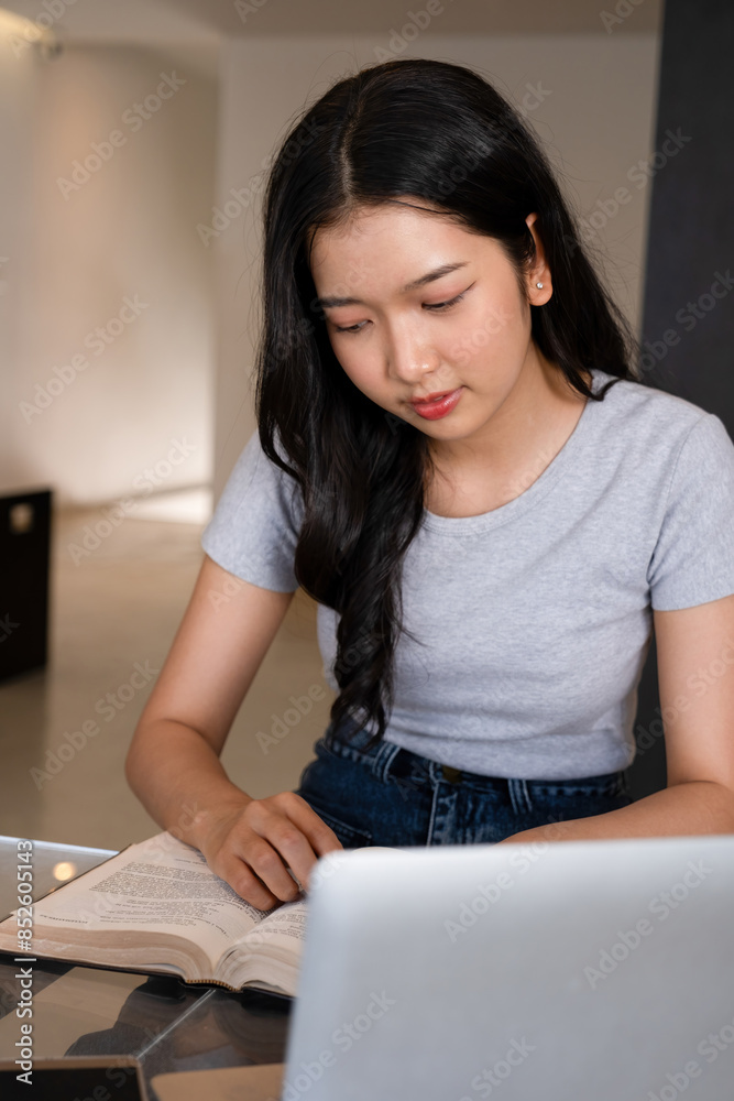 Young woman engages in business study at workspace. Young woman engages in business study at workspace.