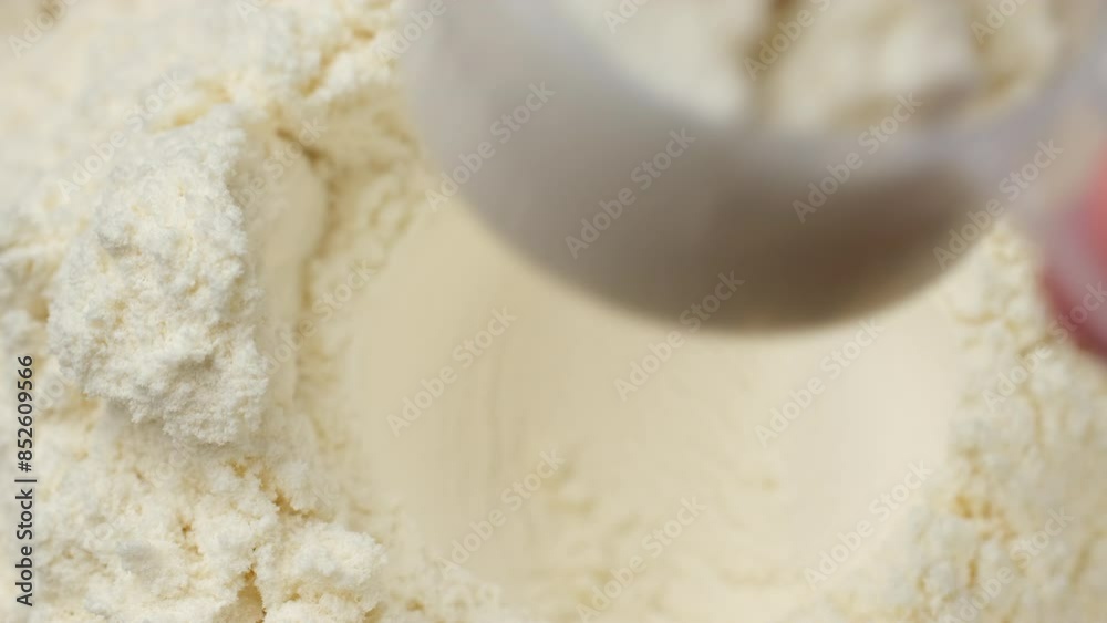 Take out a measuring spoon filled with white protein powder Take out a measuring spoon filled with white protein powder