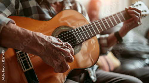 Close-up of a mature musician's hands playing an acoustic guitar, highlighting the connection between man and instrument.