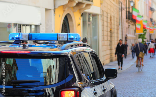 Fototapeta Naklejka Na Ścianę i Meble -  police car with flashing lights patrolling city streets