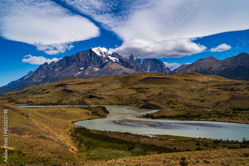 Mont Almirante Nieto and Torres del Paine, behind a meandering turquoise river, carving up the clouds