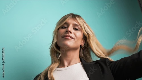 Happy transgender businesswoman playing with hair and puckering lips