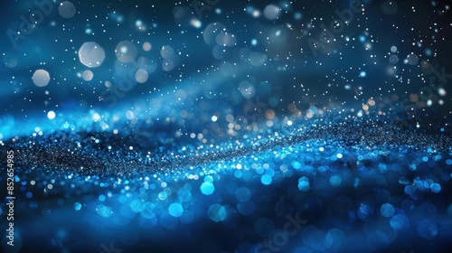 A blue abstract background with bokeh lights and glittering particles